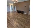 Spacious living room featuring new laminate flooring, a ceiling fan, and neutral paint tones at 223 W Fiesta Key Loop, Deland, FL 32720