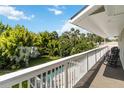 Relaxing balcony view overlooking the pool and beautiful, lush, green backyard at 2250 Davis Dr, New Smyrna Beach, FL 32168
