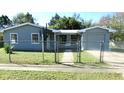 A gray house behind a gray chainlink fence on a sunny day at 2366 Florida Dr, Deltona, FL 32738