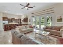 Spacious living room with neutral tones, natural light, and an open floorplan to the kitchen at 2770 Red Wing Vlg, Deland, FL 32720