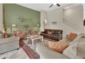 Elegant living room featuring a fireplace, comfortable seating, and a staircase at 2770 Red Wing Vlg, Deland, FL 32720