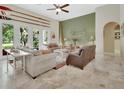 Bright living room with high ceilings, neutral tones, and multiple seating areas at 2770 Red Wing Vlg, Deland, FL 32720