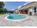 Backyard with a kidney-shaped swimming pool, patio area, and lounge chairs perfect for outdoor relaxation at 307 Ravenshill Way, Deland, FL 32724