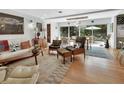Inviting living room featuring stylish mid-century modern furniture and sliding doors to the patio at 319 N Salisbury Ave, Deland, FL 32720