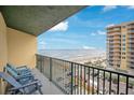 Enjoy ocean views from this condo balcony with chairs, perfect for relaxing and taking in the coastal scenery at 3647 S Atlantic Ave # 7C, Daytona Beach, FL 32118
