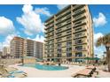 Resort style pool with ample seating located adjacent to the building at 3647 S Atlantic Ave # 7C, Daytona Beach, FL 32118