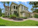 Inviting two-story home with a lush, landscaped front yard and stone accents at 3839 Calliope Ave, Port Orange, FL 32129