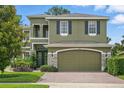 Well-maintained home featuring an attached garage and lush landscaping at 3839 Calliope Ave, Port Orange, FL 32129