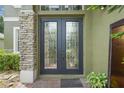 Elegant double front doors with decorative glass and stone pillar accents at 3839 Calliope Ave, Port Orange, FL 32129