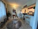 Cozy dining area with table, chairs, bar seating, and bistro decor at 411 N Halifax Ave # 208, Daytona Beach, FL 32118