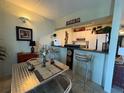 Inviting dining area with stainless steel chairs and a bar area for entertaining at 411 N Halifax Ave # 208, Daytona Beach, FL 32118