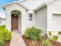 Inviting front entrance with a beautiful landscape and walkway leading to the front door at 422 Armoyan Way, New Smyrna Beach, FL 32168