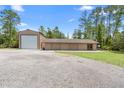 Spacious garage and workshop, offering ample storage and workspace for hobbies and projects, complemented by a wide driveway at 43350 Natchez St, Deland, FL 32720
