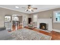 Spacious living room features a cozy fireplace, hardwood floors, and stylish decor at 441 N Julia Ave, Deland, FL 32720