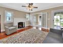 Cozy living room features hardwood floors, a fireplace, and access to the patio at 441 N Julia Ave, Deland, FL 32720
