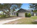 This beautifully landscaped property showcases a spacious driveway and a well-maintained two-car garage at 510 Apollo Ave, Deltona, FL 32725