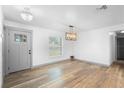 Inviting entryway featuring modern lighting, neutral walls, new flooring, and ample natural light through a large window at 510 Apollo Ave, Deltona, FL 32725