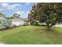 Charming single-story home boasts a two-car garage and well-manicured lawn with mature landscaping at 5445 Turton Ln, Port Orange, FL 32127