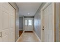 Hallway featuring tile floors and a white front door with glass inserts at 65 Sycamore Cir, Ormond Beach, FL 32174