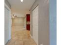Hallway showcasing neutral paint colors, tile flooring, and closet space at 65 Sycamore Cir, Ormond Beach, FL 32174