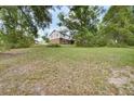 Expansive backyard with lush green grass and mature trees at 658 Westchester Dr, Deland, FL 32724