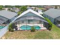 Aerial view of a private screened-in pool and patio area in the backyard at 824 Casterton Cir, Davenport, FL 33897