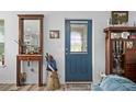 Bright entryway featuring a blue door, classic decor, and elegant furnishings at 832 Donnelly Pl, Daytona Beach, FL 32114