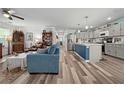 Open-concept living room with hardwood floors seamlessly connects to a modern kitchen at 832 Donnelly Pl, Daytona Beach, FL 32114