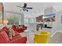 Inviting living room featuring a large window, neutral walls, and modern furnishings at 893 Assembly Ct, Reunion, FL 34747