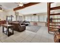 Spacious living room with a vaulted ceiling, comfortable leather seating, and large windows at 910 Braddock Rd, Enterprise, FL 32725
