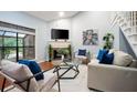 Cozy living room showcasing a fireplace, lots of natural light, and modern decor at 940 Douglas Ave # 189, Altamonte Springs, FL 32714