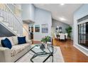 Open living area featuring hardwood floors, natural light, and a view into the dining room at 940 Douglas Ave # 189, Altamonte Springs, FL 32714