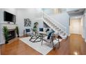 Bright living room with high ceilings, wood floors, a fireplace, and staircase at 940 Douglas Ave # 189, Altamonte Springs, FL 32714