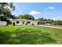 Well-manicured front lawn with bright yellow home, white trim, and an attached garage at 952 N Fairbairn Dr, Deltona, FL 32725