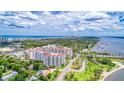 Expansive aerial photograph of a white condo building near the water, with city views in the distance at 1 John Anderson Dr # 3170, Ormond Beach, FL 32176
