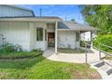 One-story home boasts a well-kept lawn, covered entrance, and convenient accessibility with handrails at 101 N Hill Ave # 6, Deland, FL 32724