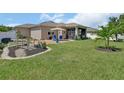 Expansive backyard featuring a serene patio area and a decorative bridge over a landscape bed at 1018 River Falls Cir, Deland, FL 32720