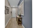 Welcoming entryway with neutral colors, stylish decor, and light wood-look tile flooring at 1018 River Falls Cir, Deland, FL 32720