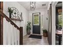 Welcoming foyer with tiled flooring, wood accents, and natural light streaming through the front door at 10460 Burrows St, Orlando, FL 32832