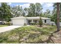 Charming single-story home with an attached two-car garage and fresh landscaping at 1094 Lolita St, Orange City, FL 32763