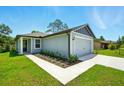 Attractive single-Gathering home with a two-car garage and a beautifully landscaped entrance at 1161 Kenway Ave, Deltona, FL 32738