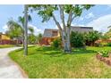 Inviting condo featuring a well-maintained lawn, privacy fence, patio, and mature landscaping at 122 Cedar Dunes Dr, New Smyrna Beach, FL 32169
