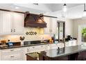 Well-lit kitchen with white cabinets, dark countertops, and modern appliances at 1261 Burning Tree Ln, Winter Park, FL 32792