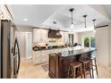Beautiful kitchen featuring dark countertops, an island, and pendant lighting at 1261 Burning Tree Ln, Winter Park, FL 32792