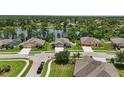 An aerial view of a neighborhood with beautiful homes situated on a lake with mature tree coverage at 1314 Lake Baton Dr, Deltona, FL 32725