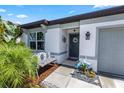 Inviting front entrance with charming bench seating, decorative yard ornaments and a beautifully landscaped walkway at 1323 Donatello Ln, Winter Haven, FL 33884