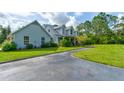 Charming two story home featuring a spacious driveway and well-manicured lawn at 1383 Tumblin Dr, New Smyrna Beach, FL 32168