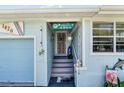 Close up of beach themed entryway with decorative surfboard, nautical decorations, and a 'Welcome Paradise Found' sign at 1420 N Grandview Ave, Daytona Beach, FL 32118