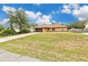 Charming single-story home with well-maintained lawn, long driveway, and a two-car garage at 1431 1St Ave, Deland, FL 32724