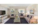 A spacious living room features a stylish couch, cozy chairs and a sleek glass table at 1612 W Grant St, Orlando, FL 32805